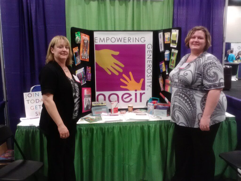 Women standing in front of Naeir Exhibit Display